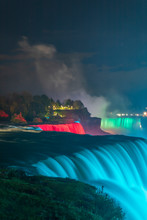 Niagara Falls - Colorful Illuminations Of The Waterfall. View From American Side