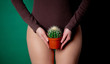 woman holds cactus in her hands at foot level
