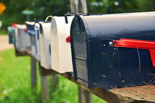 An Isolated Row Of Metal US Mail Boxes On Wooden Post In The Countryside. Spider Webs In One Of Them. Mail Concept. New York City. United States