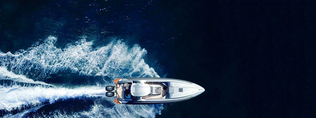 Aerial drone ultra wide top down photo of luxury rigid inflatable speed boat cruising in high speed in Aegean deep blue sea, Greece