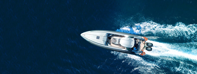 Wall Mural - Aerial drone ultra wide top down photo of luxury rigid inflatable speed boat cruising in high speed in Aegean deep blue sea, Greece