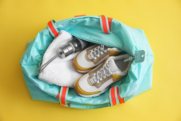 Poster - Gym bag with sports equipment on yellow background, top view