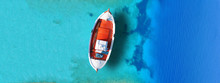 Aerial Drone Top Down Ultra Wide Photo Of Traditional Fishing Boat Docked In World Famous Paradise Beach Of Mykonos Island, Cyclades, Greece
