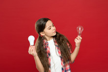 No Loss Of Enthusiasm. Little Child Choose Light Idea Bulb. Education Concept. Small School Kid Red Wall. Small Girl Lightbulb. Energy And Electricity. Creating A Great Idea. Thinking Child Girl