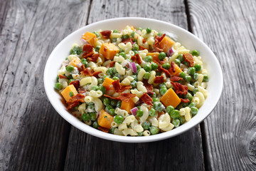 Wall Mural - pasta salad with green peas, fried bacon