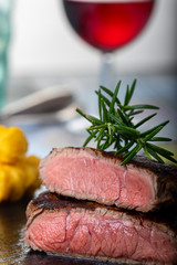 Poster - slices of grilled steak on black slate