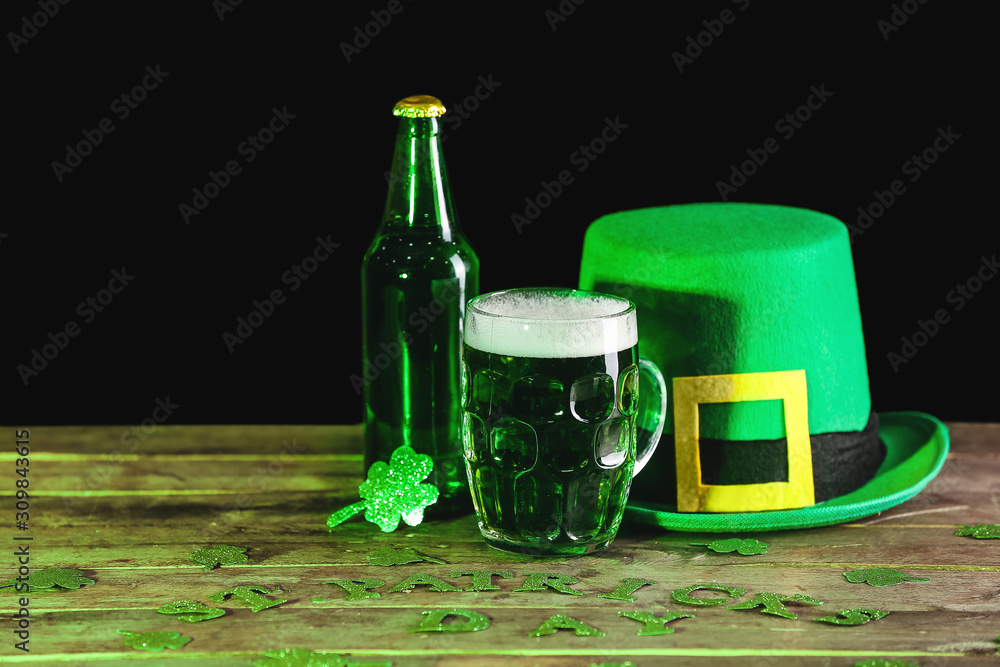 Green beer and Leprechaun's hat on table. St. Patrick's Day celebration