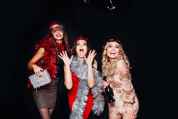 Wall Mural - Young attractive women celebrating a party, drinking champagne and dancing.