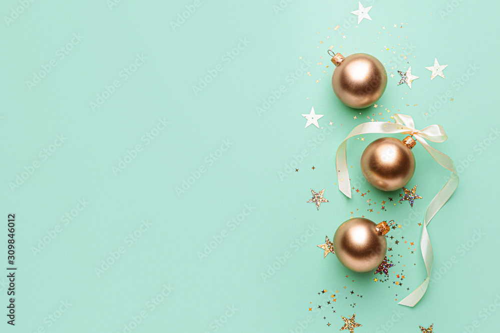 Beautiful Christmas balls with confetti on color background
