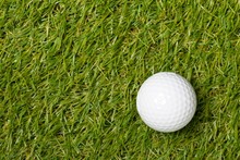 White Golf Ball On Green Grass Lawn With Copy Space Top View Flat Lay From Above With Copy Space