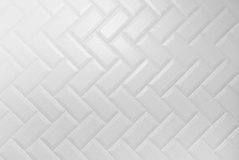 Beveled White Matt Ceramic Tiles Pattern Herringbone On Wall.