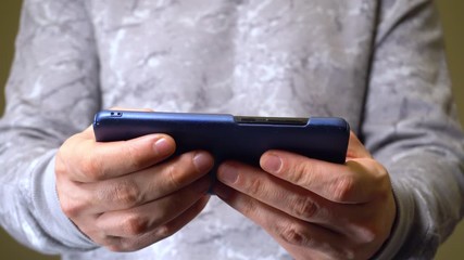 closeup shot of hands of man active playing in smartphone games