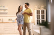© New Africa - Lovely young interracial couple dancing at home