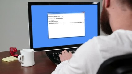 Computer programmer working at his desk and system crashes