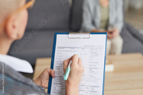 Cuadros en Lienzo High angle closeup of female psychologist filling in medical form while talking