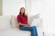 © siraphol - Portrait beautiful young asian women using computer laptop on sofa chair