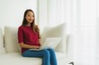 © siraphol - Portrait beautiful young asian women using computer laptop on sofa chair