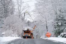Manual Worker Working On Repair Electrical Line After Winter Snow Storm
