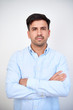 © DragonImages - Portrait of handsome serious young confident entrepreneur folding arms and looking at camera