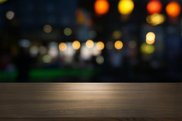 Empty dark wooden table in front of abstract blurred bokeh background of restaurant . can be used for display or montage your products.Mock up for space.