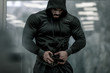 sport mind male motivation concept of epic movie hero strong bearded man in hoodie preparing for weight lifting during indoor gym workout training