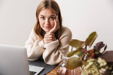 Sticker - Image of young caucasian woman using laptop and drinking tea