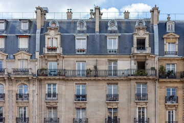 Paris House with chimney and windows. Haussmann epoque, beautiful balconies, traditional french building