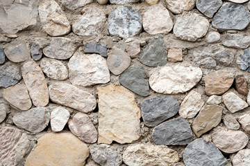 Wall Mural - the wall of stones monotonous color of different sizes and shapes