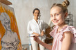 © Viacheslav Yakobchuk - Nice happy girl posing for camera in art room