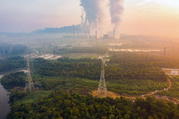 Aerial view of Mae Moh Coal Power Plant with smoke and toxic air from chimney. Factory industry. Electricity tower in energy or pollution environment concept. Lampang City, Thailand