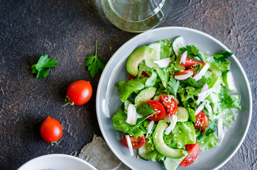 Fresh green organic salad with raw ingredients close up.