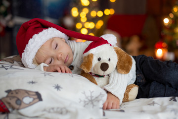 Poster - Sweet beautiful blond toddler boy, sleeping in bed with toy