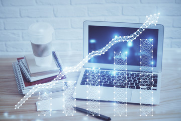 Financial graph colorful drawing and table with computer on background. Multi exposure. Concept of international markets.