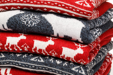 Wall Mural - Stack of folded knitted Christmas turtleneck sweaters closeup