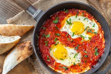 Wall Mural - Shakshouka served in a frying pan