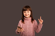 © Marharyta Hanhalo - Little cute charming girl child showing thumbs up pointing to a copy space, place to insert above her head. Images for advertising, logo insertion or inscription