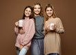 © igor_kravtsov - Cute happy girls with cups on brown background