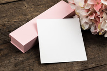 Pastel Pink Hydrangea Flowers, Gift Box And A Piece Of Paper On A Wood Background. Copy Space For Text