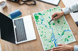© LIGHTFIELD STUDIOS - cropped view of travel agent pointing with pen at map on wooden desk