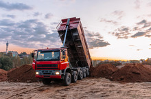 A Dump Truck Is Dumping Gravel On An Excavation Site