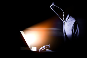 Hacker with laptop. Computer crime.
