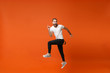 © ViDi Studio - Excited crazy young man in casual white t-shirt posing isolated on bright orange wall background studio portrait. People lifestyle concept. Mock up copy space. Having fun, fooling around, jumping.