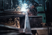 Man Is Working At Metal Factory, He Is Welding A Piece Of Rail Using Special Tools.