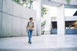 © GalakticDreamer - Student carrying laptop and walking near concrete wall
