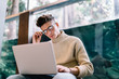 © GalakticDreamer - Concentrated young man in glasses using laptop