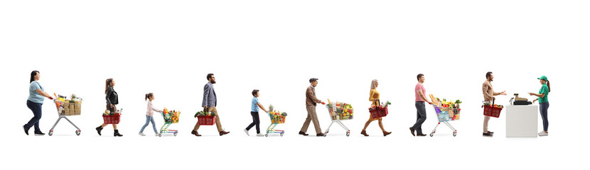 Long queue of people waiting at the cash register in a supermarket