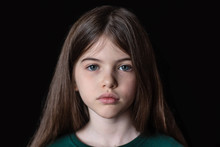 Closeup Portrait Of Serious, Sad Little Girl Isolated On Black Background