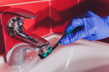 Wall Mural - Water tap in detail with limescale close up soiled bathroom Calcified faucet. gloves for washing