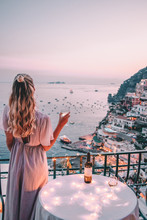 Young Woman With Blonde Hair On Balcony In Positano Italy