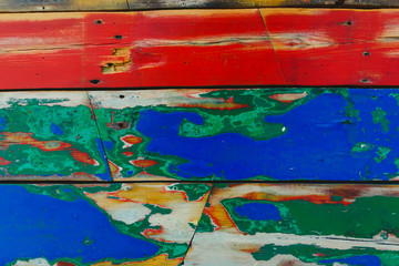 Painted wooden boards of various colors aged, natural texture background.